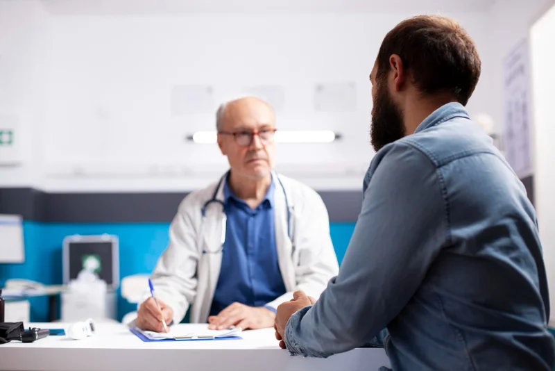 Healthcare professional in a clinical setting discussing potential Mitolyn side effects and safety precautions with a patient.